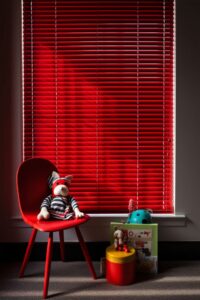 Glossy Red Venetian Blinds In A Playroom